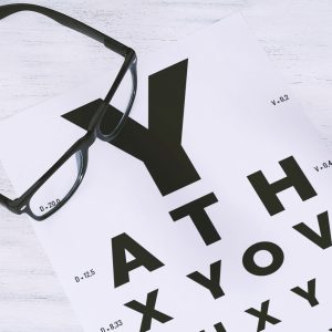 Spectacle frames on top of an Eye Chart
